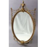 A 20th century gilt composition oval wall mirror in the George III style, inset bevelled mirror