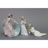 A Lladro Daisa porcelain female figure (No. 5663); & two ditto girl figures, each wearing a