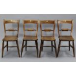 A set of four early 20th century ash rail-back cottage dining chairs with hard seats, & on ring-