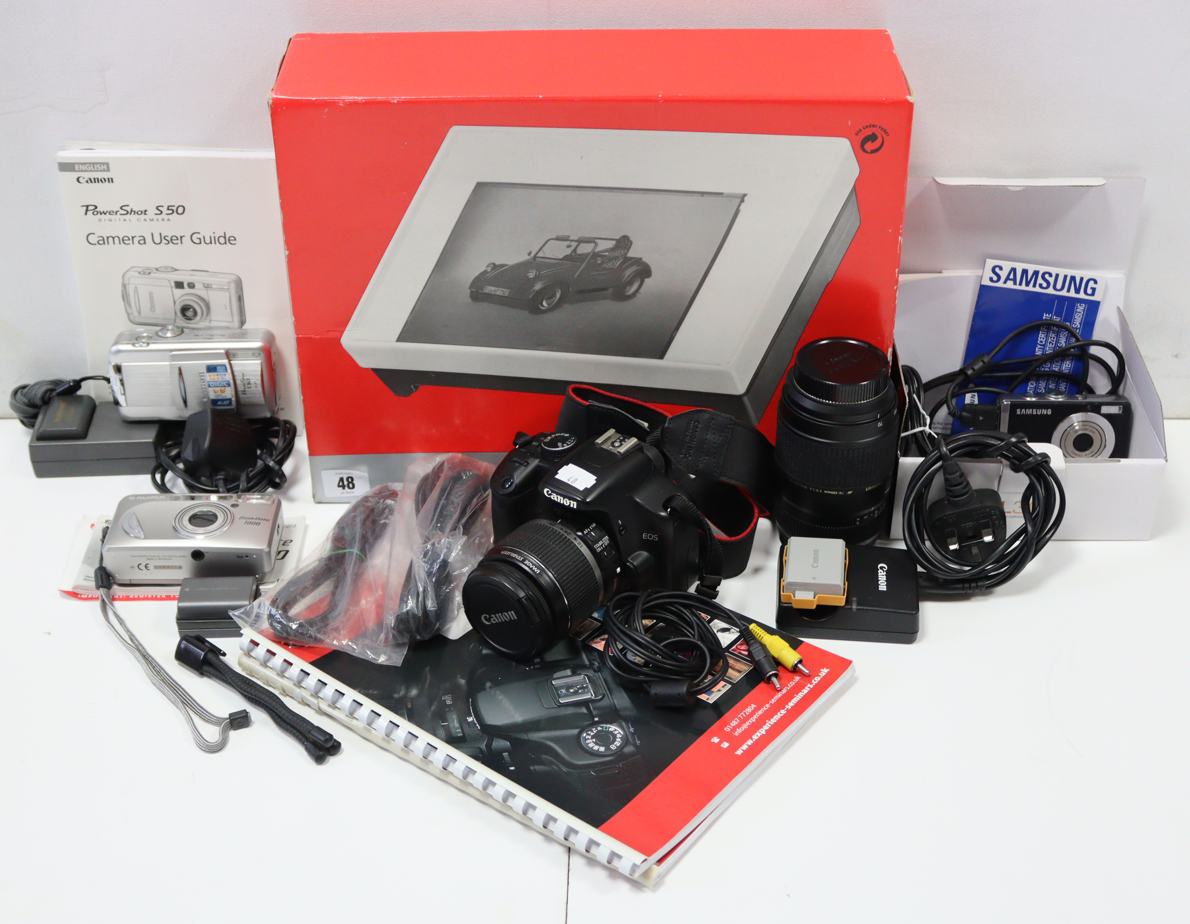 A Canon “EOS 450D” digital camera with lens; together with various other cameras; a light-box; & a