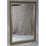A large gilt-frame rectangular wall mirror inset bevelled plate, & with raised foliate border, 40” x