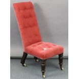 A late 19th century nursing chair, upholstered buttoned crimson velour, & on short turned legs