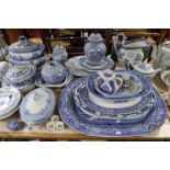 A blue & white “Willow” pattern toilet jug; a ditto meat plate; four other blue & white meat plates;