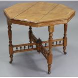 A late Victorian oak octagonal centre table(splits to top) on four fluted & turned legs with ceramic