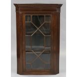 An early 19th century inlaid-mahogany standing corner display cabinet with moulded dentil cornice