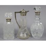 An Edwardian cut-glass water jug with silver mount, Sheffield 1908, 10¾” high; together with two