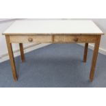 A pine kitchen table inset white Formica to the rectangular top, fitted two frieze drawers, & on