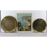 Two eastern brass engraved circular trays, 26¾”, & 22” diameter; & a large coloured print, 27½” x