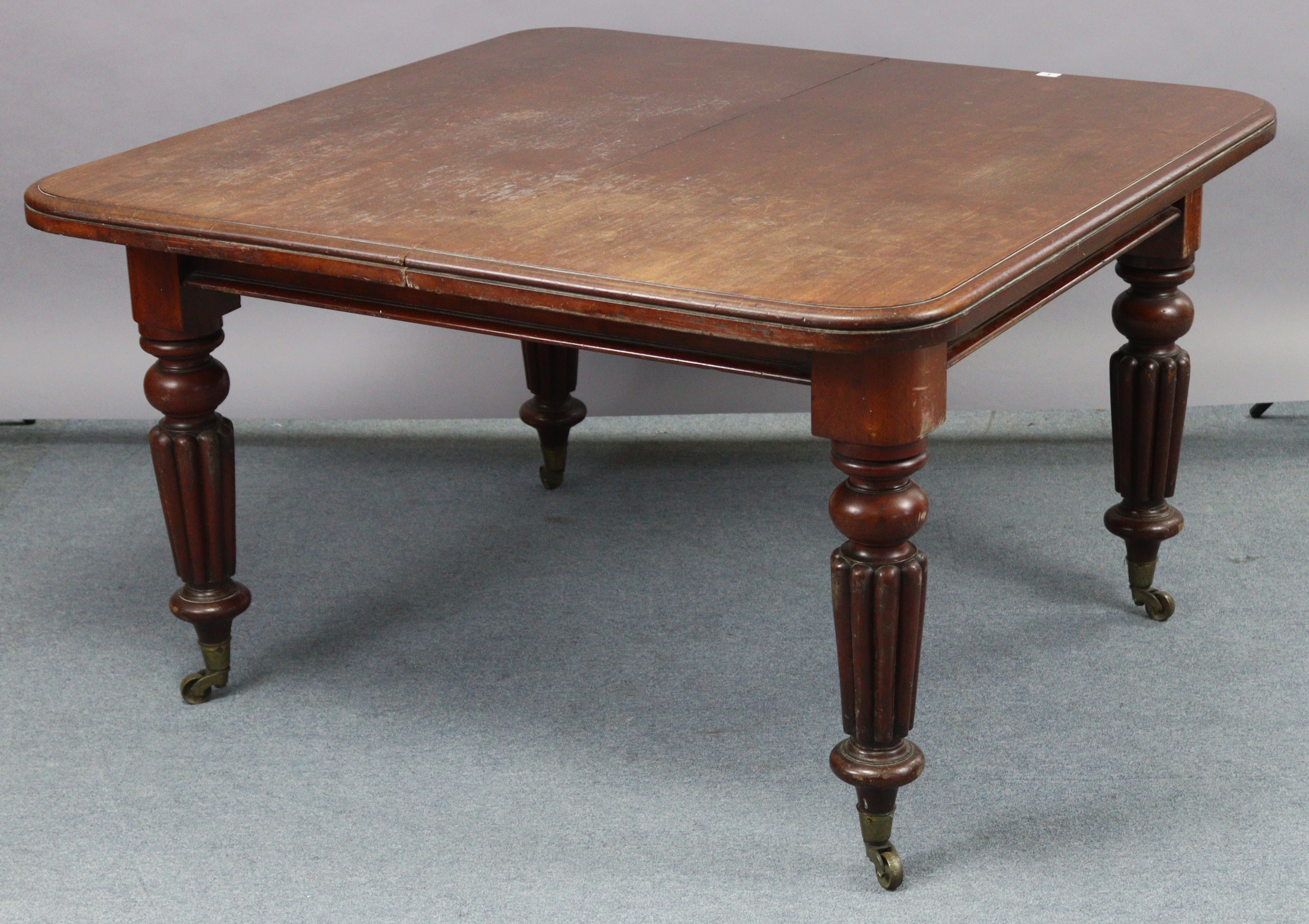 A Victorian mahogany extending dining table, with moulded edge & rounded corners to the