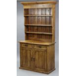 A Victorian-style pine dresser, the upper part fitted three open shelves & with panelled back, the