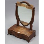 An early 20th century inlaid-mahogany shield-shaped swing dressing table mirror fitted three small