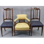 A Victorian low tub-shaped chair with padded seat, back & arms upholstered yellow damask, with