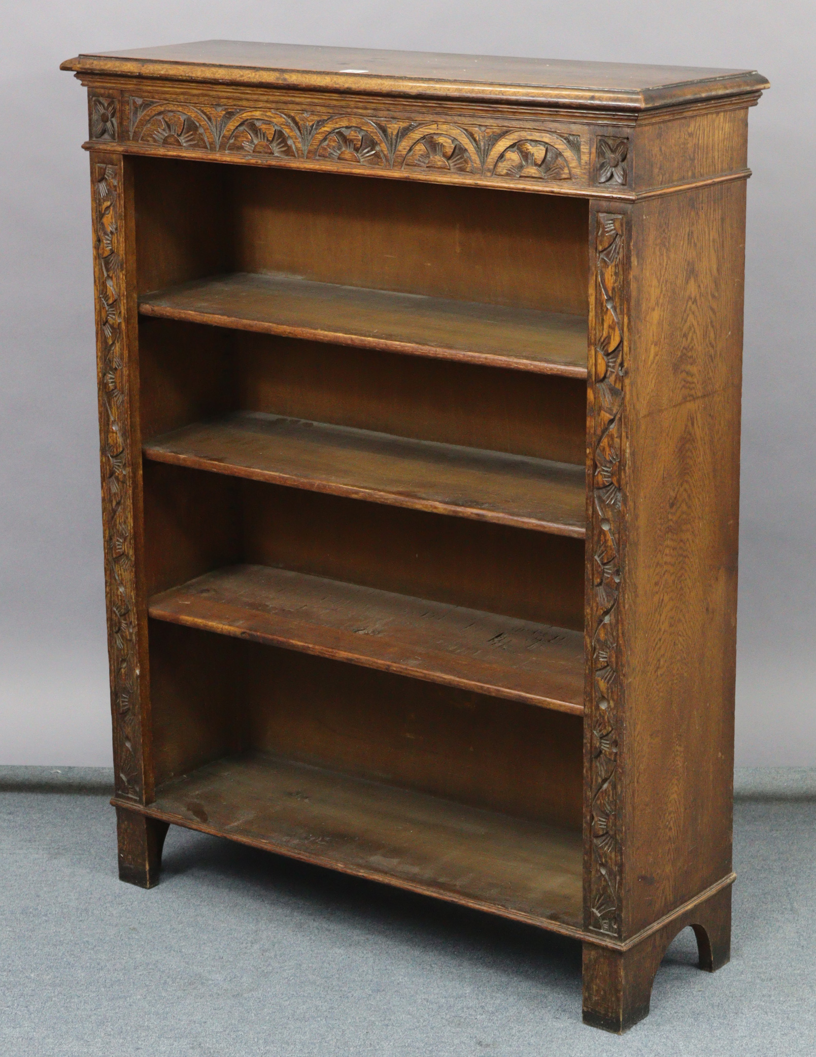 A carved oak standing open bookcase fitted three shelves, 36” wide x 46½” high.