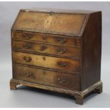 A George III inlaid oak bureau, with fitted interior enclosed by sloping fall-front above four