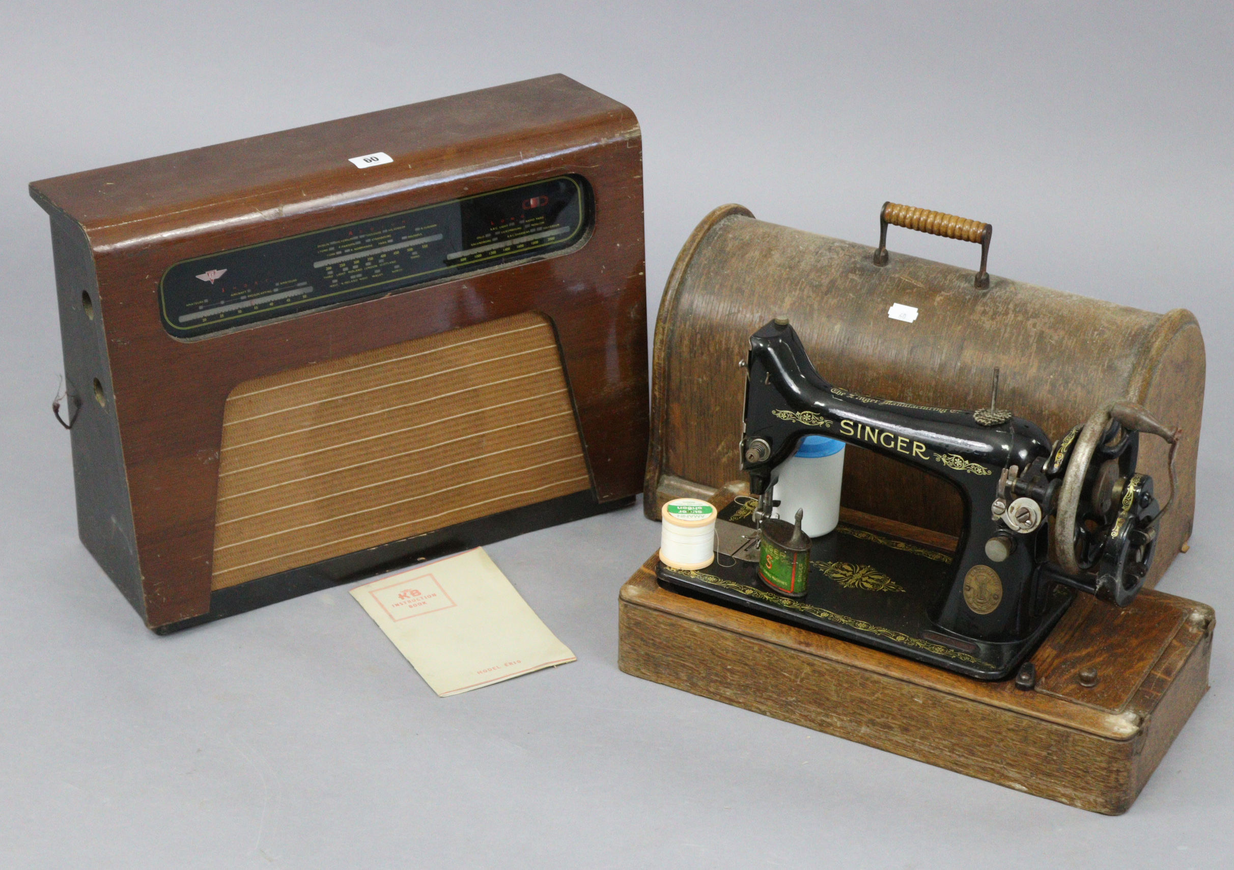 A Kolster – Brandes valve radio in walnut case; & a Singer hand sewing machine with oak case.