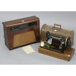 A Kolster – Brandes valve radio in walnut case; & a Singer hand sewing machine with oak case.