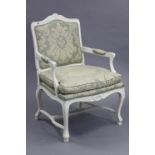 A continental-style white painted & carved wooden-frame armchair, with padded seat & back