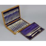 A set of twelve silver plated fish knives & forks, in oak case; & a similar pair of fish servers,