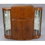 A mid-20th century walnut bow-front cocktail cabinet, with fitted interior enclosed by hinged lift-