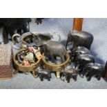 An oriental carved hardwood trinket box, 11¼” wide; together twelve carved ebony elephant models;