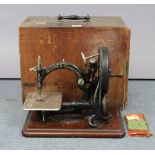 An early-mid 20th century Wilcox & Gibbs hand sewing machine, with case.
