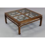 A Chinese hardwood large square low coffee table, inset four bevelled-glass panels to the top, &