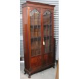 An Edwardian mahogany tall bookcase with seven adjustable shelves enclosed by pair of glazed & panel