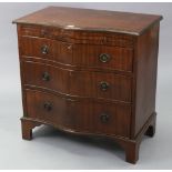 A reproduction mahogany serpentine-front low chest, fitted brushing slide above three long graduated