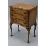 A walnut inverted serpentine-front three-drawer bedside chest, on slender cabriole legs & pad