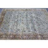 A Persian pattern carpet of ivory & cream ground, & with all-over repeating multi-coloured