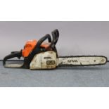 A Stihl “MS 180” petrol-driven chainsaw.