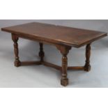 An oak refectory-style draw-leaf dining table, on four bulbous-turned legs with plain stretchers,