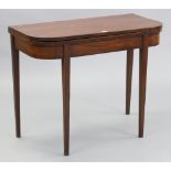 A late 19th century mahogany tea table with rounded corners to the rectangular fold-over top, & on