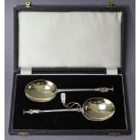 A pair of late Victorian silver serving spoons with apostle terminals, London 1888, cased.