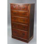 A walnut tall upright chest, fitted two short & four long graduated drawers with wrought-iron
