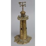 A cast brass table lamp in the form of a lighthouse, on rocky base; 14” high.