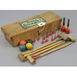 An early-mid 20th century “Table Croquet” game, in deal case.