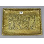 A Newlyn-type brass rectangular tray with raised fish design to centre, 10½” x 14¾”.