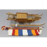 A carved wooden model of a Philippines Balangay boat with sails, 30” long.