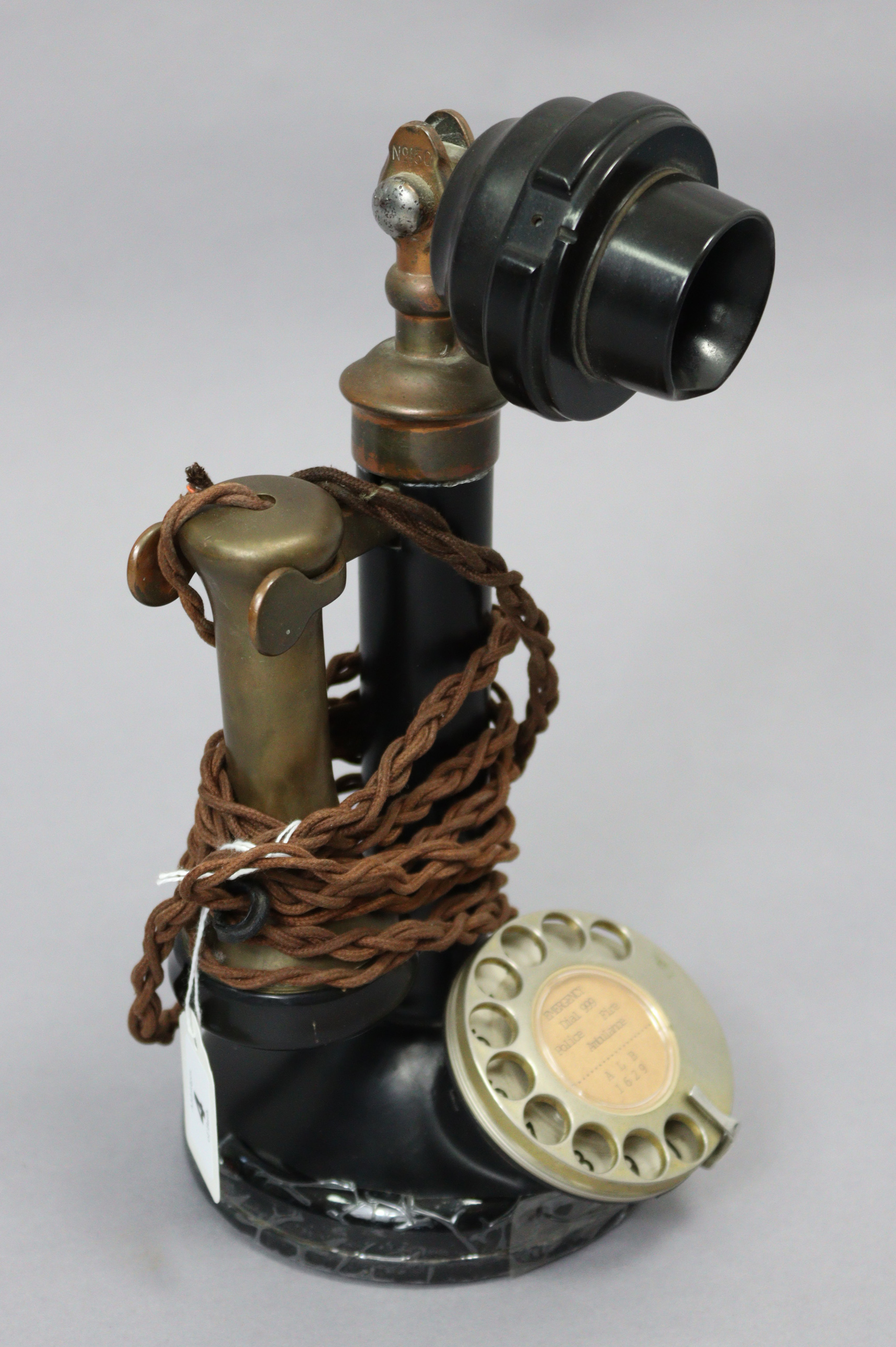 A mid-20th century candlestick telephone (Model No. 150), in black Bakelite case with brass & chrome