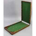 An early 20th century mahogany folding bagatelle table inset green baize, bears label “A. W.