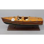 A wooden model of a speed boat, on plinth base, 19¼” long.