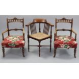 A pair of late Victorian beech rail-back elbow occasional chairs with padded seats & on short ring-
