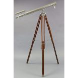 A reproduction chrome-plated astronomer’s telescope with wooden tripod, 38½” long.