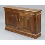 A pine dwarf cupboard with an adjustable shelf enclosed by pair of fielded panel doors, & on