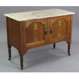 An Edwardian oak marble-top washstand enclosed by pair of panel doors with painted Arts & Crafts sty