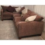 A corner settee with loose cushions to the seat & back upholstered brown velour, & on short square