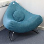 A contemporary easy chair of triangular form, upholstered turquoise material, & on silvered-metal