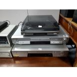 A Sony radio receiver; a Panasonic DVD player; a Sony turntable; a Sony video cassette recorder; & a
