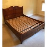 A continental-style walnut double bedstead with fielded panels to the headboard, & complete with